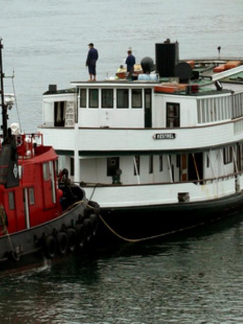 The Kestrel is pushed along by a tug. Photo: NZ Herald