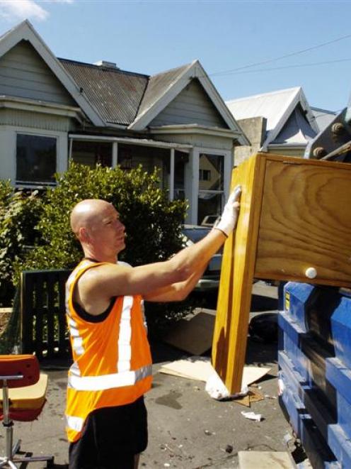 The late Andrew Simes loads unwanted furniture into a rubbish truck during a collection in the...