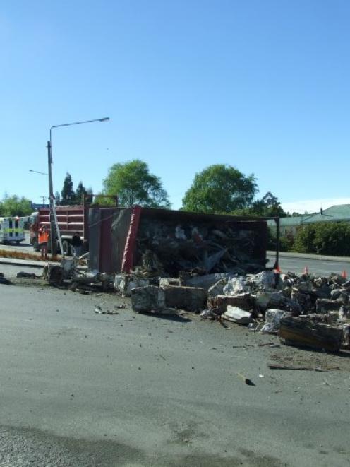 The load of the truck's rear trailer spilled on to the road as the rtuck was heading out of...
