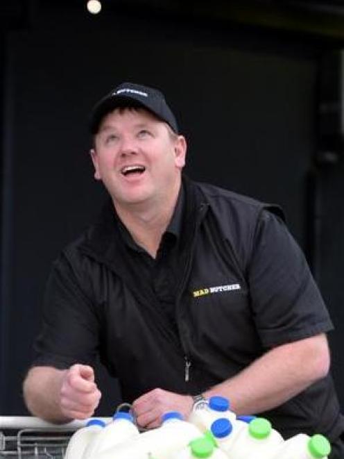 The Mad Butcher Dunedin owner Tony Coulston flips a $2 coin, the price of 2 litres of milk in the...