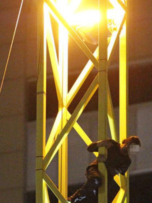 The man climbed up the 'Screamer' in Auckland's CBD last night and refused to come down. Photo /...