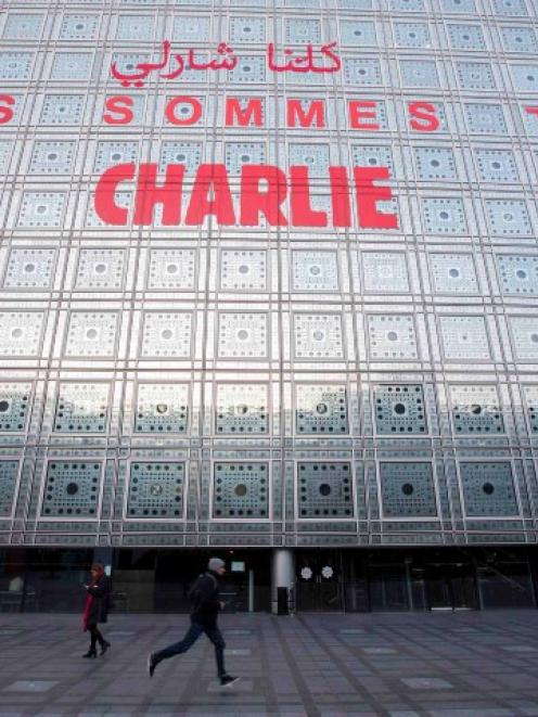 The message 'We are all Charlie' is seen on the facade of the Arab World Institute in Paris, in...