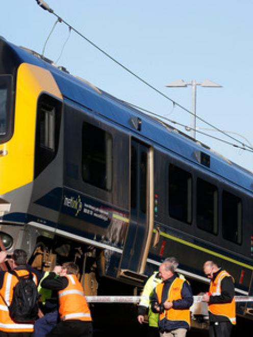 The Metlink Matangi train is inspecting by Transrail staff after crashing over a barrier at the...