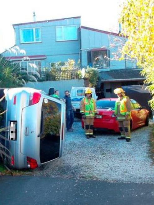 The Mitsubishi hatchback used for a driving lesson on Sunday rests on its side in a Dunedin...