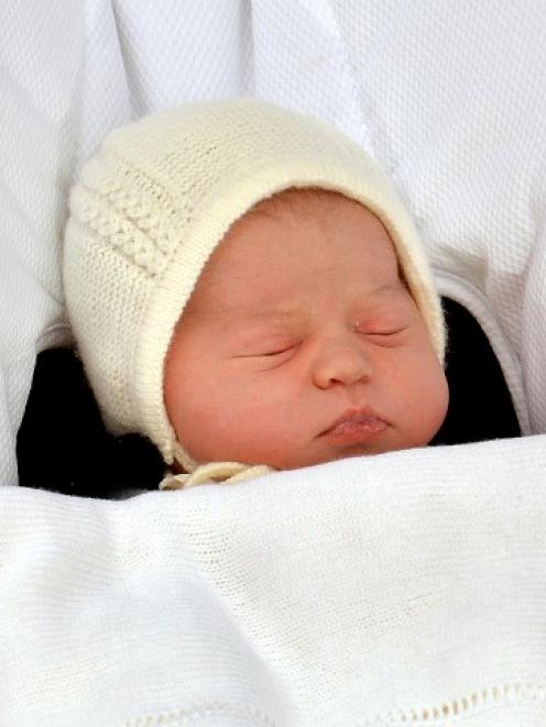 The new princess sleeps as she is carried in a car seat from St Mary's Hospital, in London....