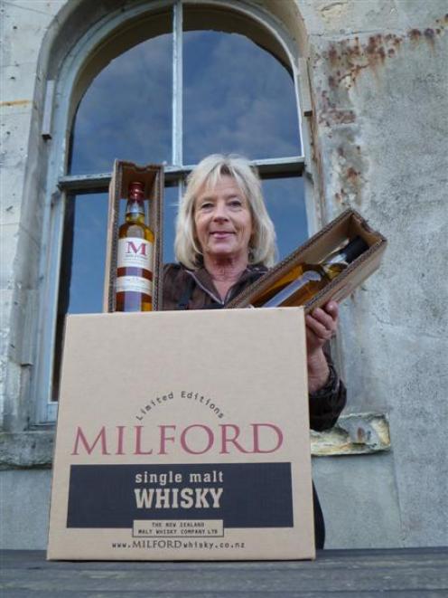 The New Zealand Whisky Company shop manager Kay Hansen packs malt whisky yesterday for export to...