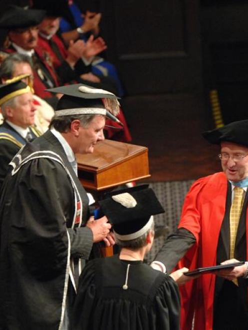 The next University of Otago chancellor, John Ward, caps current chancellor Lindsay Brown with an...