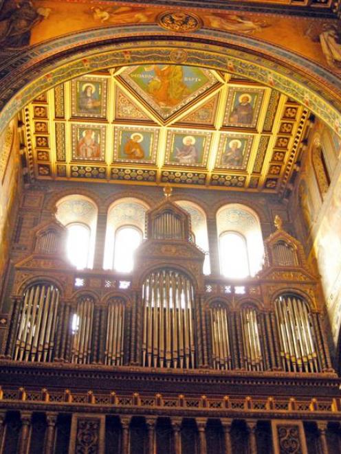 The pipe organ and ornately painted walls at St Peter's Cathedral in Pecs, Hungary. Photo:...