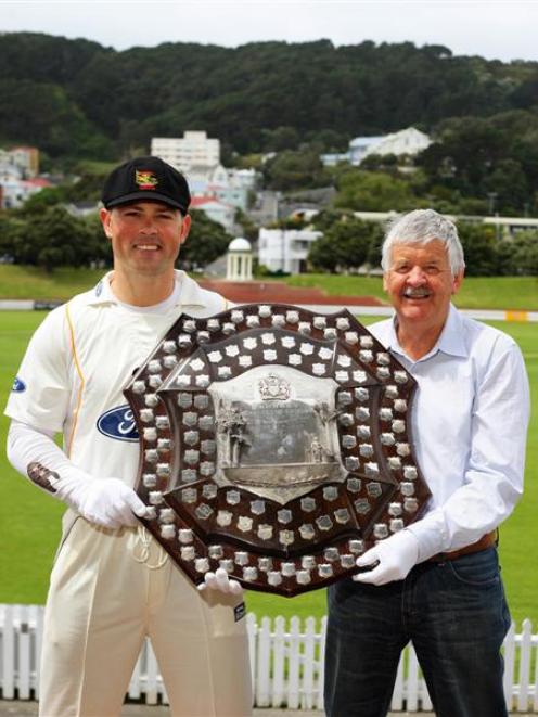 The Plunket Shield is carefully held by Wellington cricket captain Matthew Bell (left) and former...