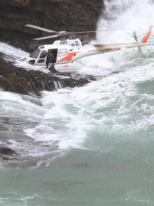 The police national dive team uses an underwater camera suspended from a helicopter to look...