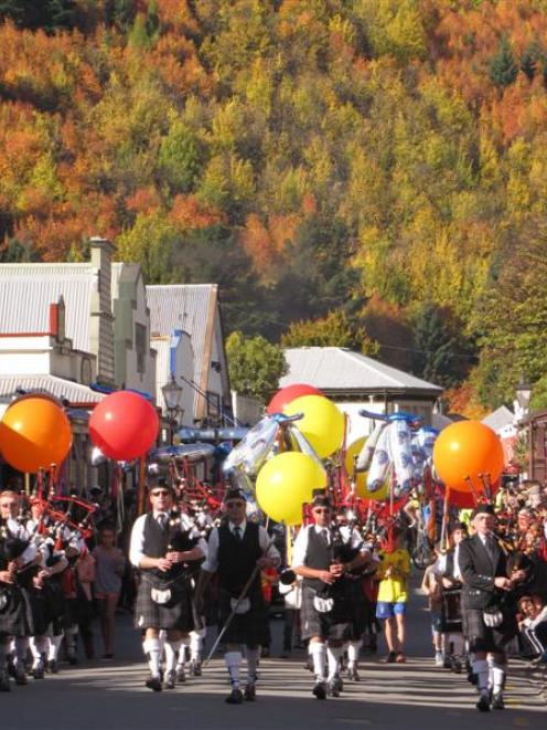 The Queenstown and Southern Lakes Pipe Band leads the Arrowtown Autumn Festival street parade on...