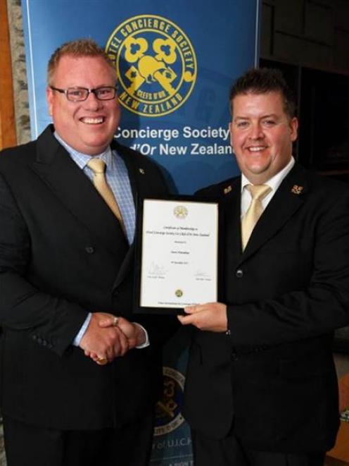 The Rees Hotel head concierge Steve Hanrahan (right) accepts the Les Clef d'Or, hospitality's top...