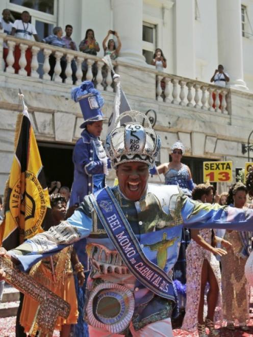 The Rei Momo, or Carnival King Wilson Neto dances during the handing over of the ceremonial key...