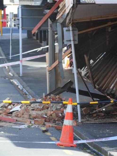 The remains of a veranda and parapet are strewn across part of Rattray St following yesterday's...
