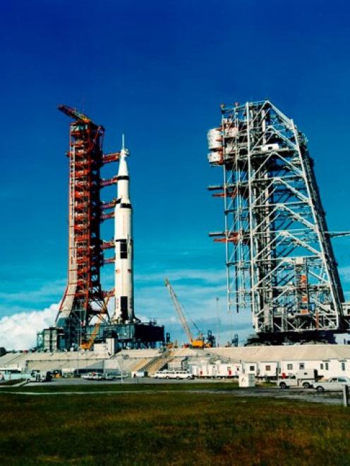 The Saturn V rocket carrying the Apollo 11 spaceflight sits on the launch pad at the Kennedy...