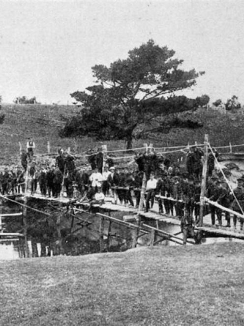 The South Island Battalion of the New Zealand Railway Engineers with a bridge built across the...