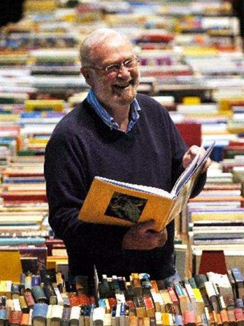 The Star Regent 24-hour Book Sale convener Doug Lovell enjoys browsing through a selection of...