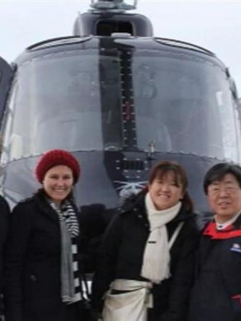 The stranded tourists pose for a photograph on the Lammerlaw Range. Photo courtesy of One News.