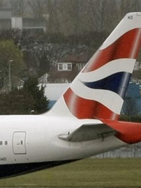 The tail-fin of a British Airways plane is seen at Heathrow. Photo by AP.