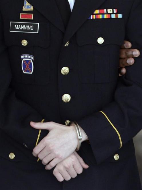 The uniform, handcuffs, nametag and service ribbons of  Bradley Manning are seen as he departs...