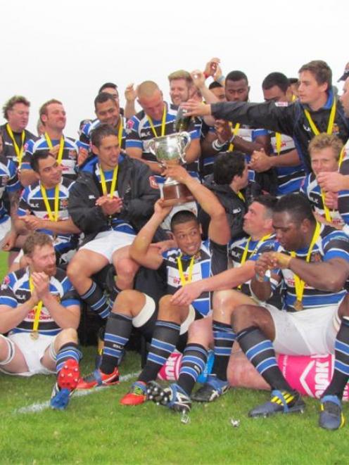 The Wanganui players celebrate with the Lochore Cup after beating North Otago 14-12 in yesterday...