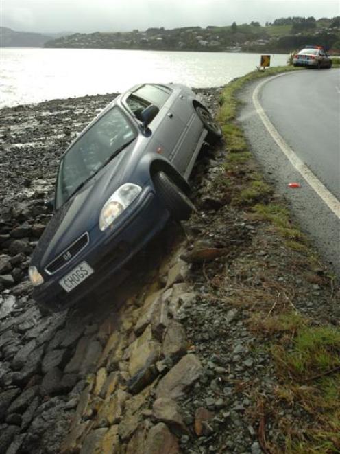 The woman driving this car was rescued by another driver after it slid off Portobello Rd during a...