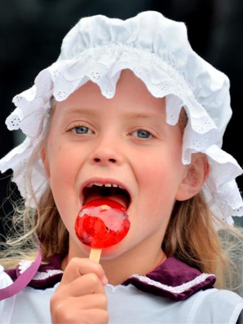 Thea Davis (8) of Dunedin enjoys a  toffee apple at the Victorian Fete in Oamaru yesterday. Photo...