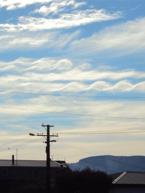 These spiral-like clouds (just above the power lines), photographed at Mosgiel last Saturday, are...