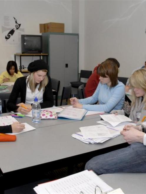 Third-year business student Curtis Morton helps first-year students with their business...