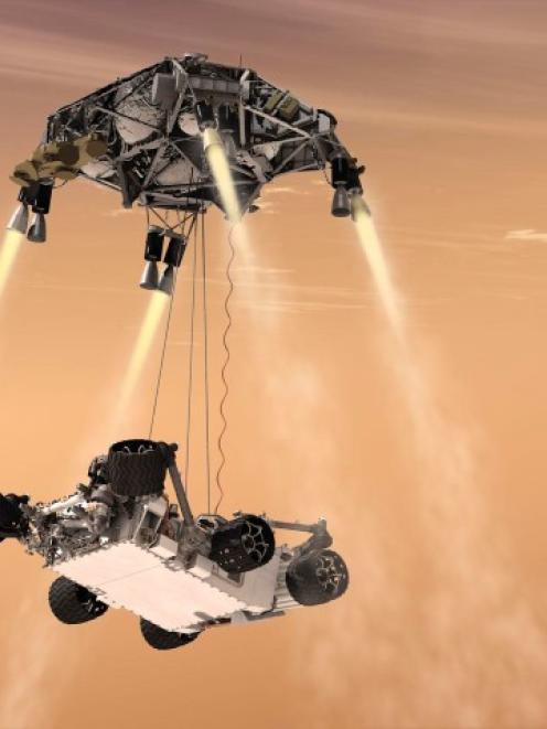 This artist's concept shows the sky crane manoeuvre during the descent of NASA's Curiosity rover...