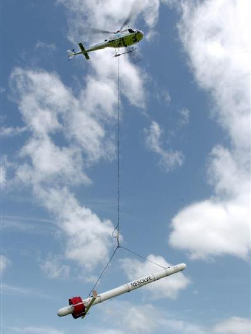 This helicopter, carrying geophysical survey equipment, is undertaking investigative work in the...