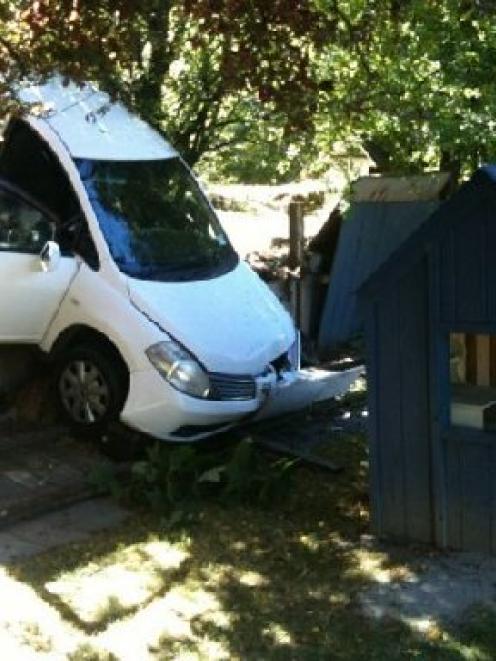 This rental car, containing  two Chinese tourists,  crashed through a fence yesterday and came to...