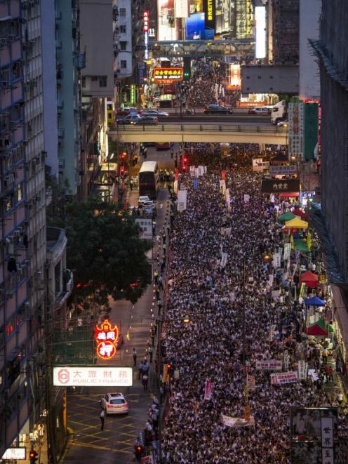 Thousands of pro-democracy protesters gather to march in the streets to demand universal suffrage...