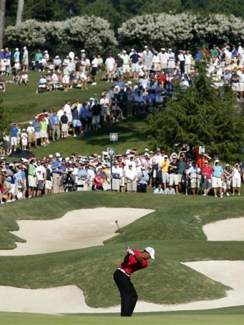 Tiger Woods hits up to the 14th green during the first round of the PGA Championship at the...