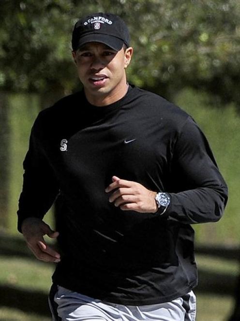Tiger Woods jogs near his home on Wednesday, February 17, 2010. Photo by AP.