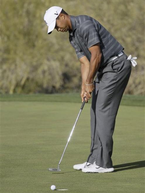 Tiger Woods misses a putt on No 18 to lose the match to Nick Watney during the Match Play...