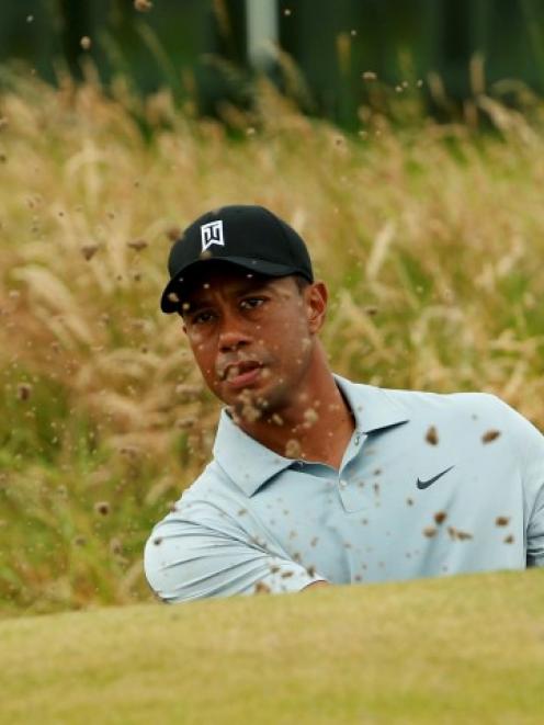 Tiger Woods practises on the chipping green ahead of the British Open Championship at the Royal...