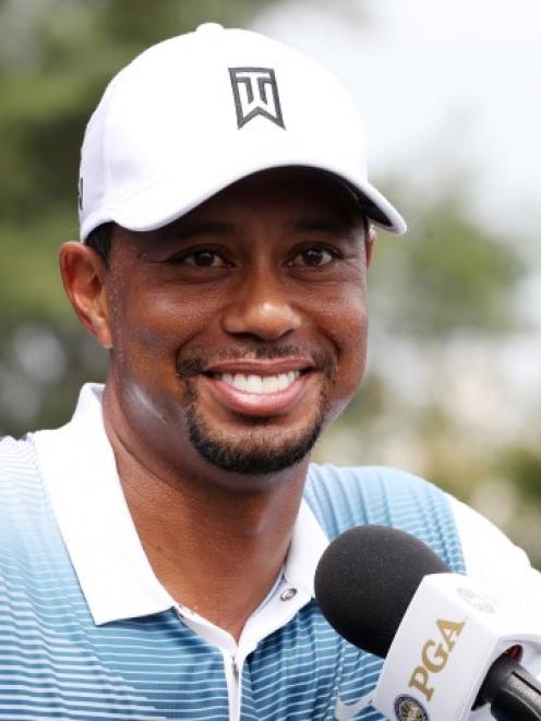 Tiger Woods speaks at a press conference after playing nine holes during practice for the PGA...