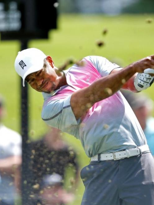 Tiger Woods plays a shot on the seventh hole during the first round of the WGC-Bridgestone...