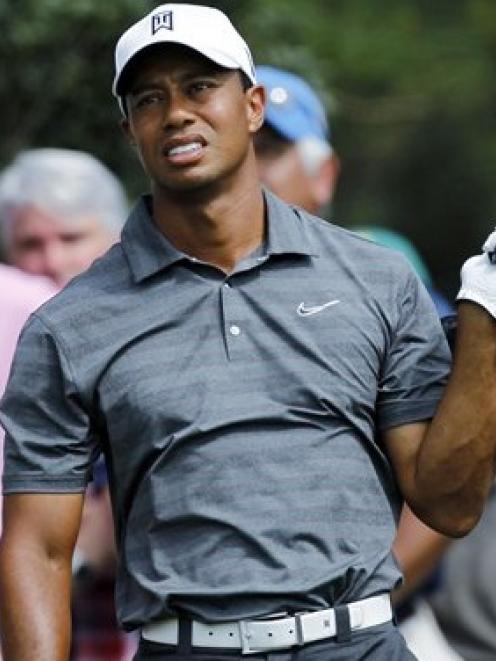 Tiger Woods watches his tee shot on the 15th hole during the first round of the Masters. (AP...