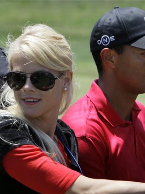 Tiger Woods' wife, Elin Nordegren, rides next to Woods after winning the US Open championship at...