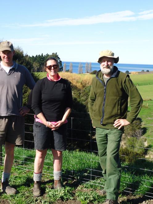 Tim (left) and Janet Penney stand in front of the fence protecting  Waitotaranui Creek with QEII...