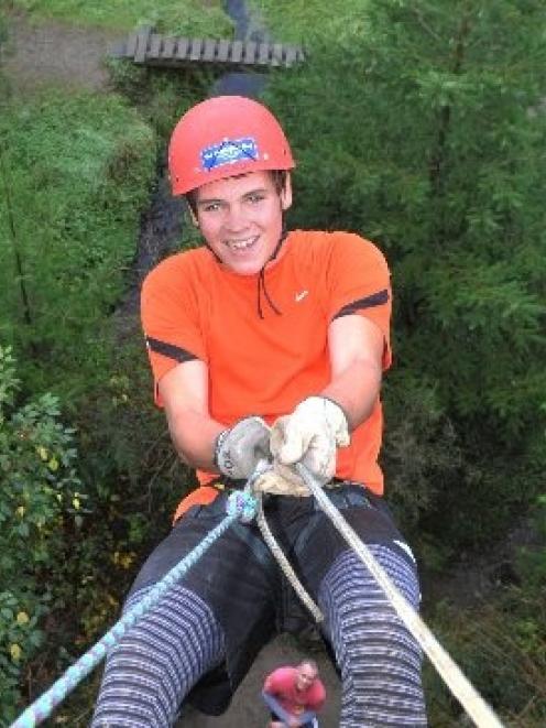 Tim Stanton (18), of Geraldine, begins his descent on the climbing wall at Berwick Camp yesterday...