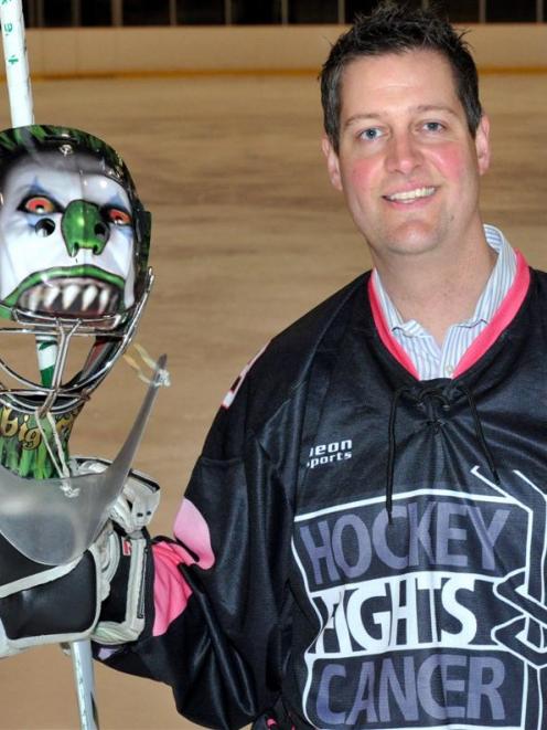 Toby Schuck shows off one of the uniforms for the fundraising match tonight. Photo by Gregor...