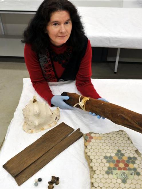 Toitu Otago Settlers Museum visitor experience manager Jennifer Evans holds a preserved piece of...