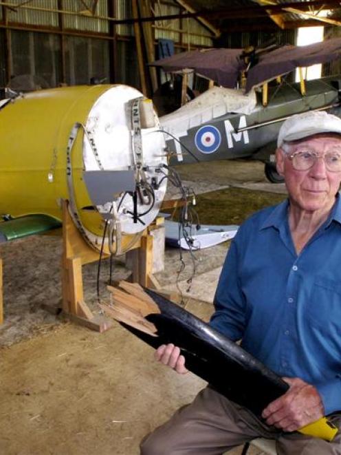 Tom Grant with his Albatros and SE 5a replica World War 1 aircraft. Mr Grant holds a piece of the...