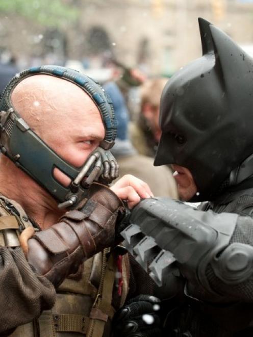 Tom Hardy as Bane and Christian Bale as Batman face off in 'The Dark Knight Rises'. (Ron Phillips...