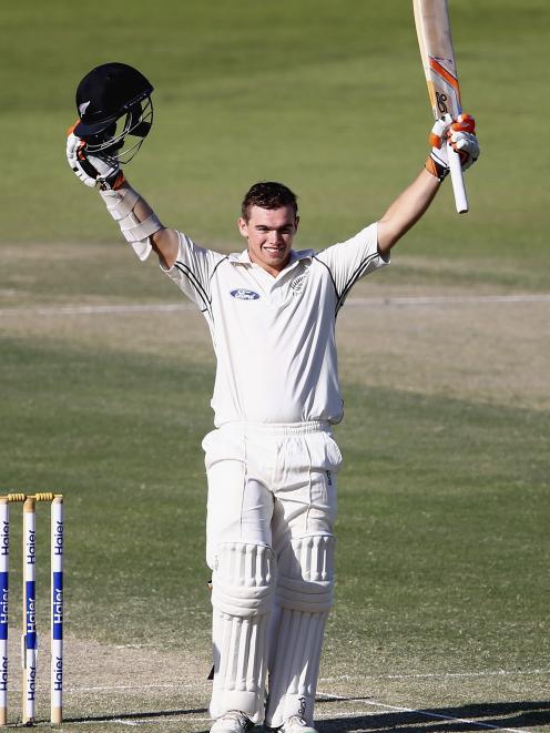 Tom Latham of New Zealand celebrates after reaching his century during Day Three of the First...