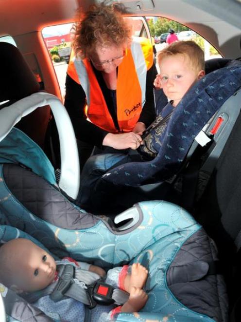 Tonia Scoullar, Otago-Southland Plunket car seat co-ordinator, shows the correct way to put Van...