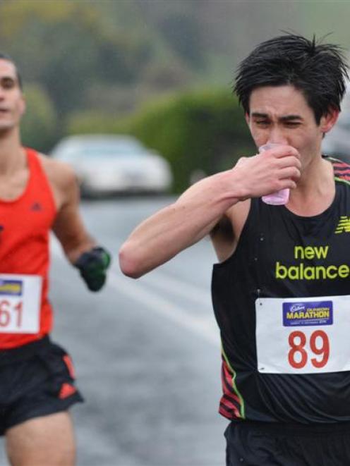 Tony Payne takes a drink on his way to victory in the Dunedin Marathon yesterday.  Romain Mirosa,...